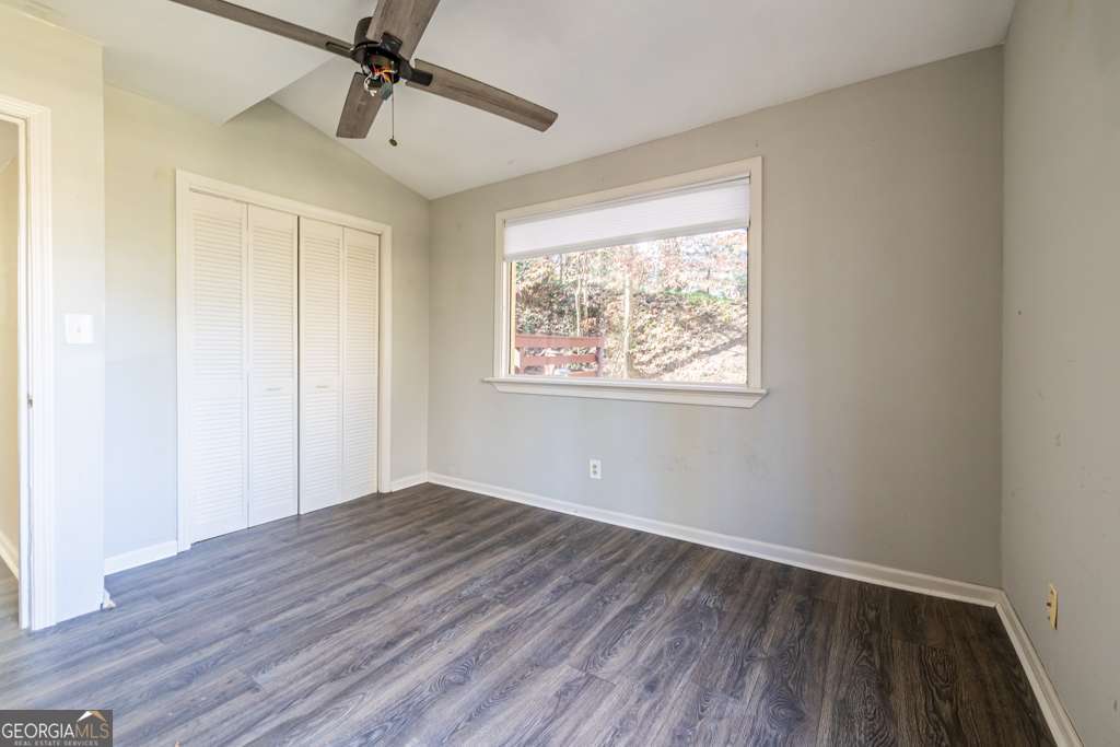 1570 Spring Lane Northwest, Unit B Atlanta, GA 30314 - Photo 20 of 26 a view of an empty room with wooden floor and a window