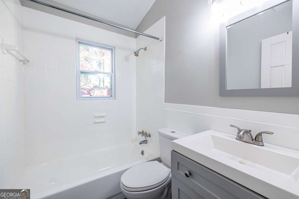 1570 Spring Lane Northwest, Unit B Atlanta, GA 30314 - Photo 21 of 26 a bathroom with a sink toilet vanity and shower