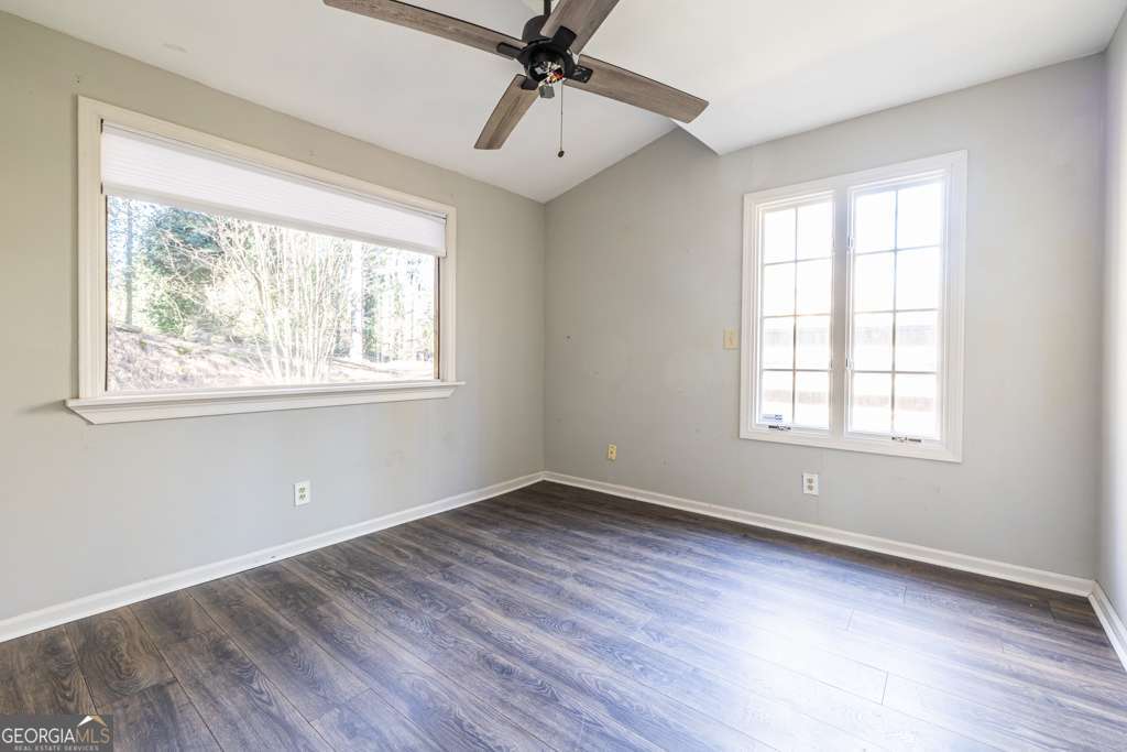 1570 Spring Lane Northwest, Unit B Atlanta, GA 30314 - Photo 22 of 26 a view of an empty room with wooden floor and a window