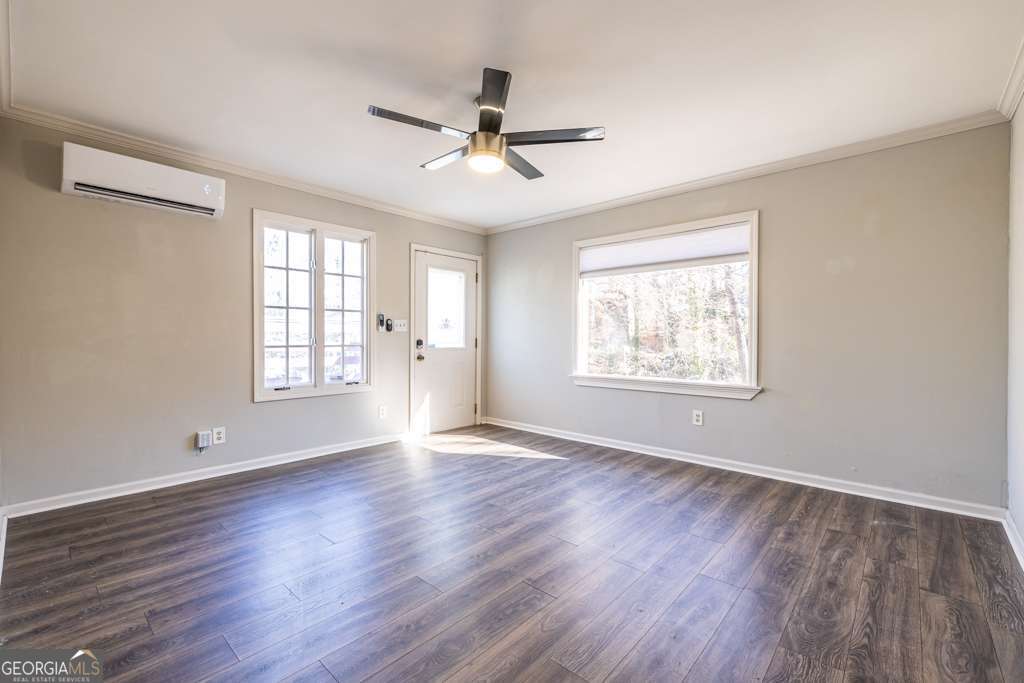 1570 Spring Lane Northwest, Unit B Atlanta, GA 30314 - Photo 5 of 26 a view of an empty room with wooden floor and a window