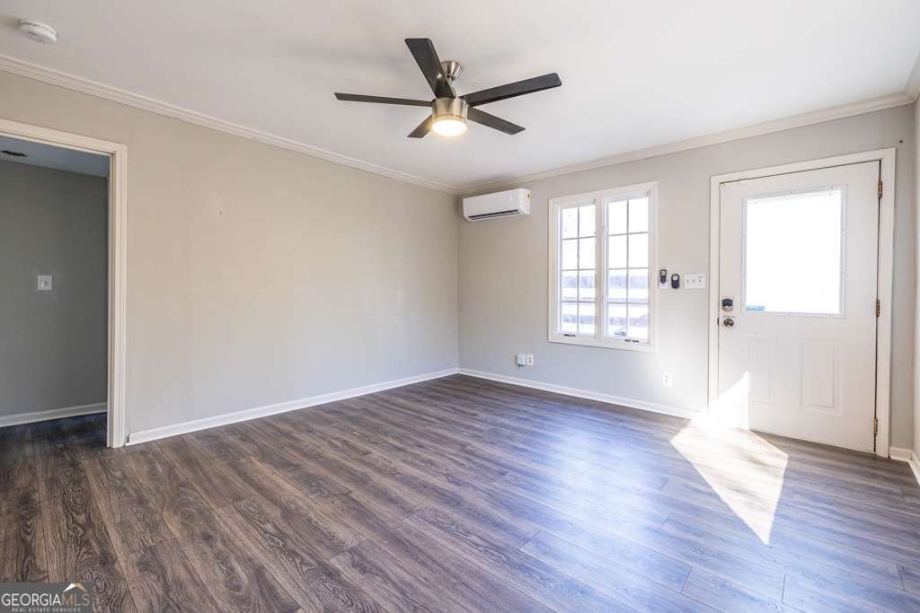 1570 Spring Lane Northwest, Unit B Atlanta, GA 30314 - Photo 7 of 26 wooden floor in an empty room with a window