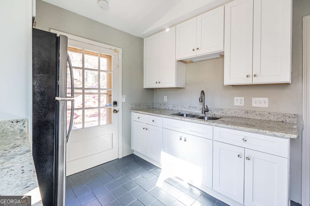 1570 Spring Lane Northwest, Unit B Atlanta, GA 30314 - Photo 9 of 26 a kitchen with granite countertop white cabinets and sink
