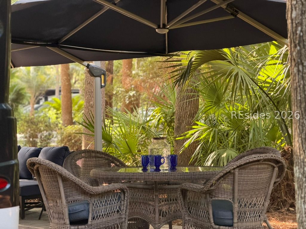 133 Arrow Road, Unit 23 Hilton Head Island, SC 29928 - Photo 4 of 22 Dinning table w/ 4 chairs under 2nd large umbrella