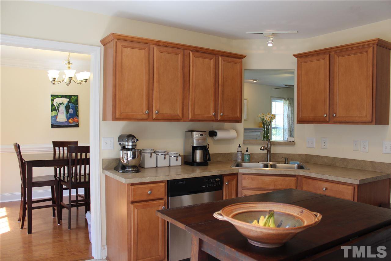 409 West Cornwallis Road Durham, NC 27707 - Photo 3 of 25 Sunny kitchen with maple cabinets, stainless appliances, gas oven and ceramic tile.
