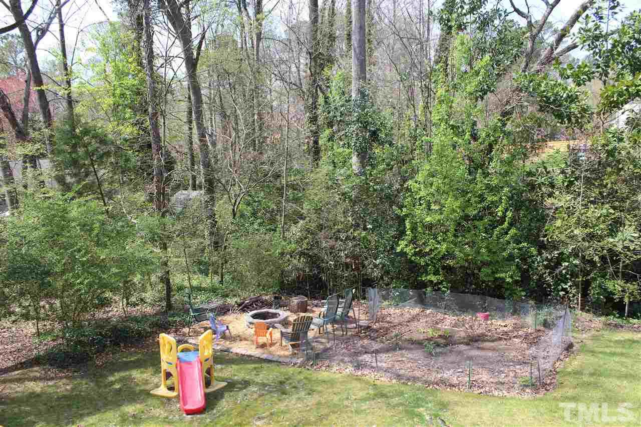 409 West Cornwallis Road Durham, NC 27707 - Photo 23 of 25 Wooded back yard with fire pit area and vegetable garden