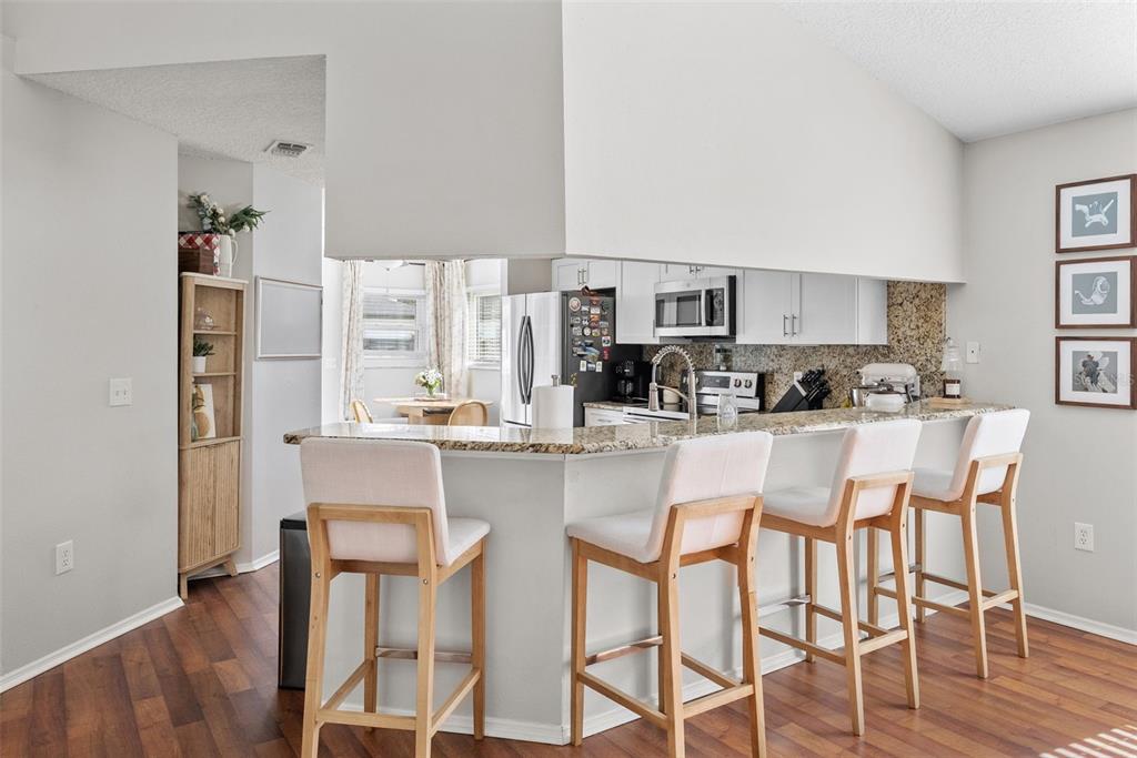 3323 West Pine Street Tampa, FL 33607 - Photo 11 of 32 a kitchen with stainless steel appliances granite countertop a table and chairs