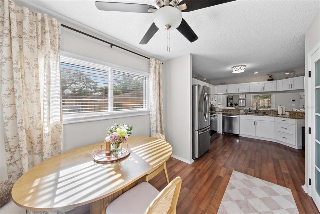 3323 West Pine Street Tampa, FL 33607 - Photo 15 of 32 a kitchen with kitchen island stainless steel appliances a sink and wooden floor
