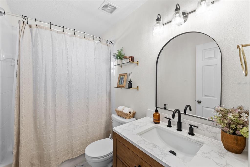 3323 West Pine Street Tampa, FL 33607 - Photo 18 of 32 a bathroom with a sink vanity mirror and toilet