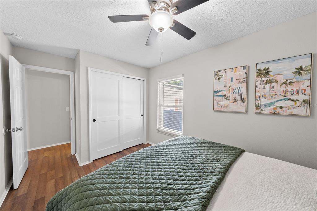 3323 West Pine Street Tampa, FL 33607 - Photo 20 of 32 a bedroom with a bed and a chandelier