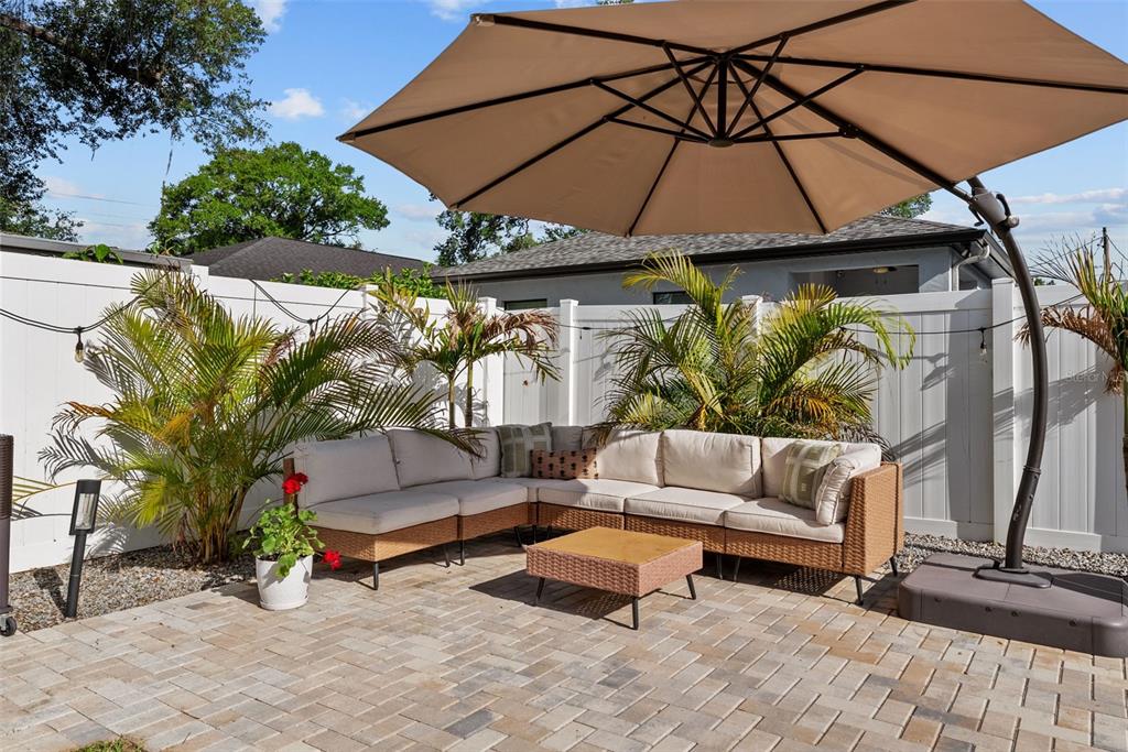 3323 West Pine Street Tampa, FL 33607 - Photo 25 of 32 a view of patio with a table and chairs under an umbrella