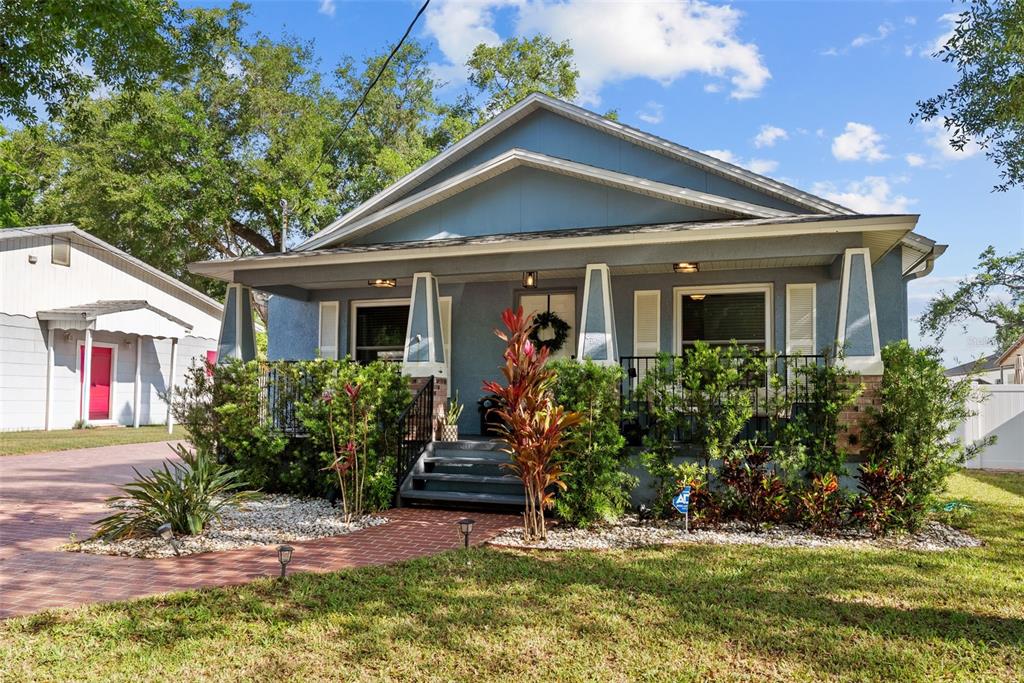 3323 West Pine Street Tampa, FL 33607 - Photo 31 of 32 a front view of a house with a yard