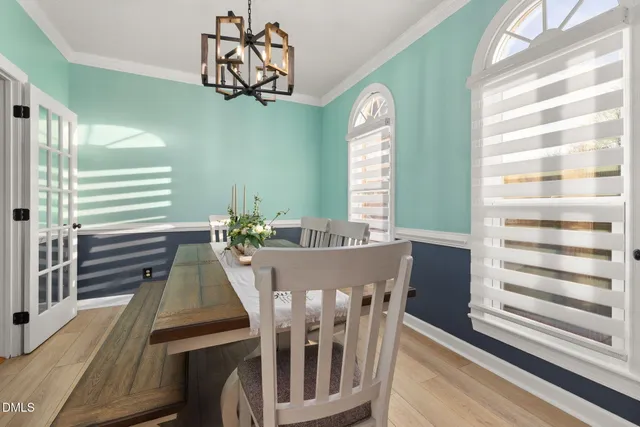 a view of a dining room with furniture and wooden floor
