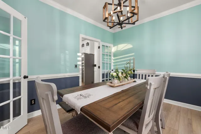 a kitchen with a sink stainless steel appliances and white cabinets