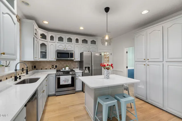 a view of a hallway to a livingroom and furniture