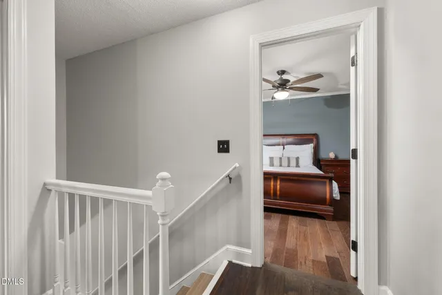 a bathroom with a granite countertop toilet sink and mirror next to a window