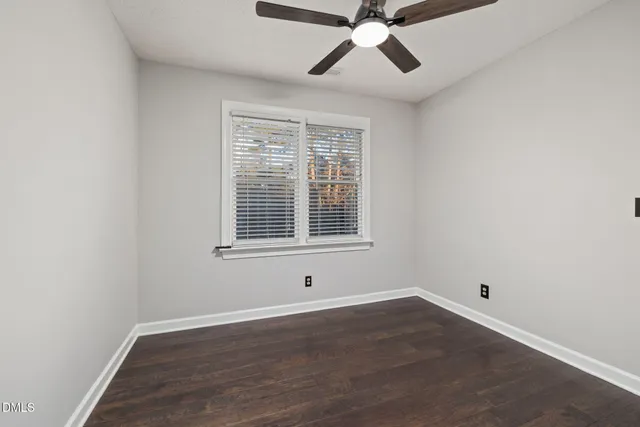 a bed room with a bed and a ceiling fan