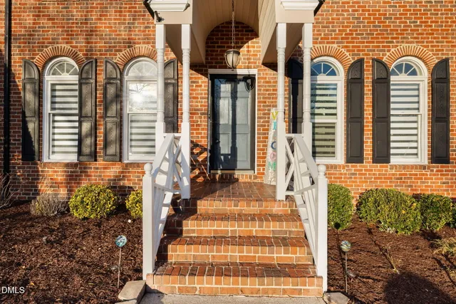 an aerial view of a house with a yard and lake view