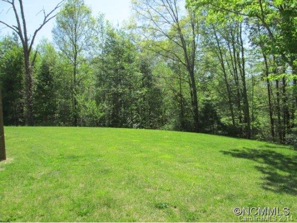 141 Prairie Cottage Road Clyde, NC 28721 - Photo 14 of 20 a view of a grassy field with trees in the background