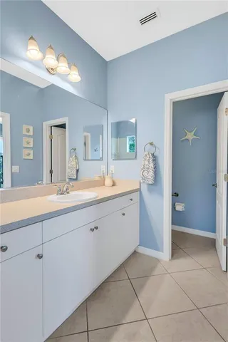 a spacious bathroom with a granite countertop sink a mirror and a shower