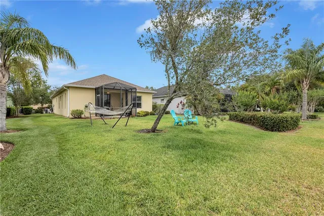 a yellow house sitting in middle of the grass