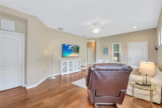 a living room with furniture and a wooden floor
