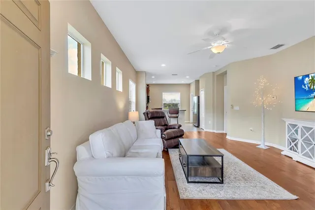 a living room with furniture and a wooden floor
