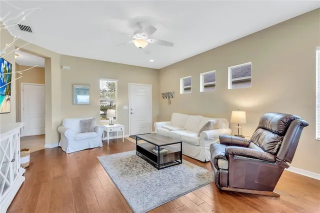 a living room with furniture and wooden floor