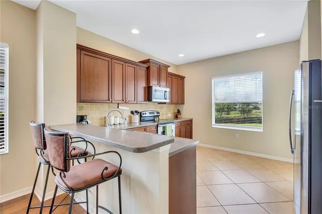 a kitchen with kitchen island granite countertop a sink cabinets and window