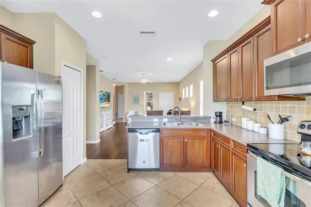 a kitchen with a sink cabinets and stainless steel appliances