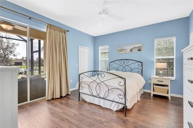 a bedroom with a bed and a large window