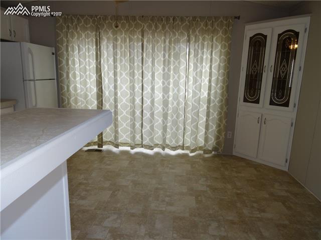3405 Sinton Road, Unit 233 Colorado Springs, CO 80907 - Photo 9 of 22 New curtains; built-in China Hutch. Plenty of room for a kitchen table, etc