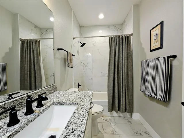 a bathroom with a double vanity sink a mirror and a shower