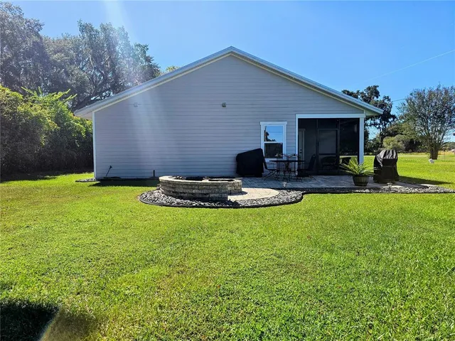 a swimming pool with outdoor seating and yard