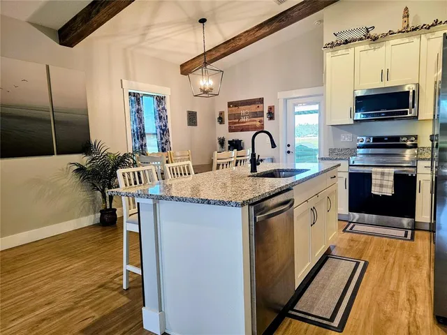 a kitchen with a sink appliances and cabinets