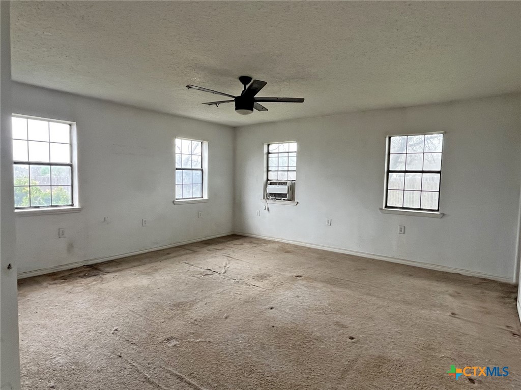 104 East Elms Road Killeen, TX 76542 - Photo 11 of 24 an empty room with windows and ceiling fan