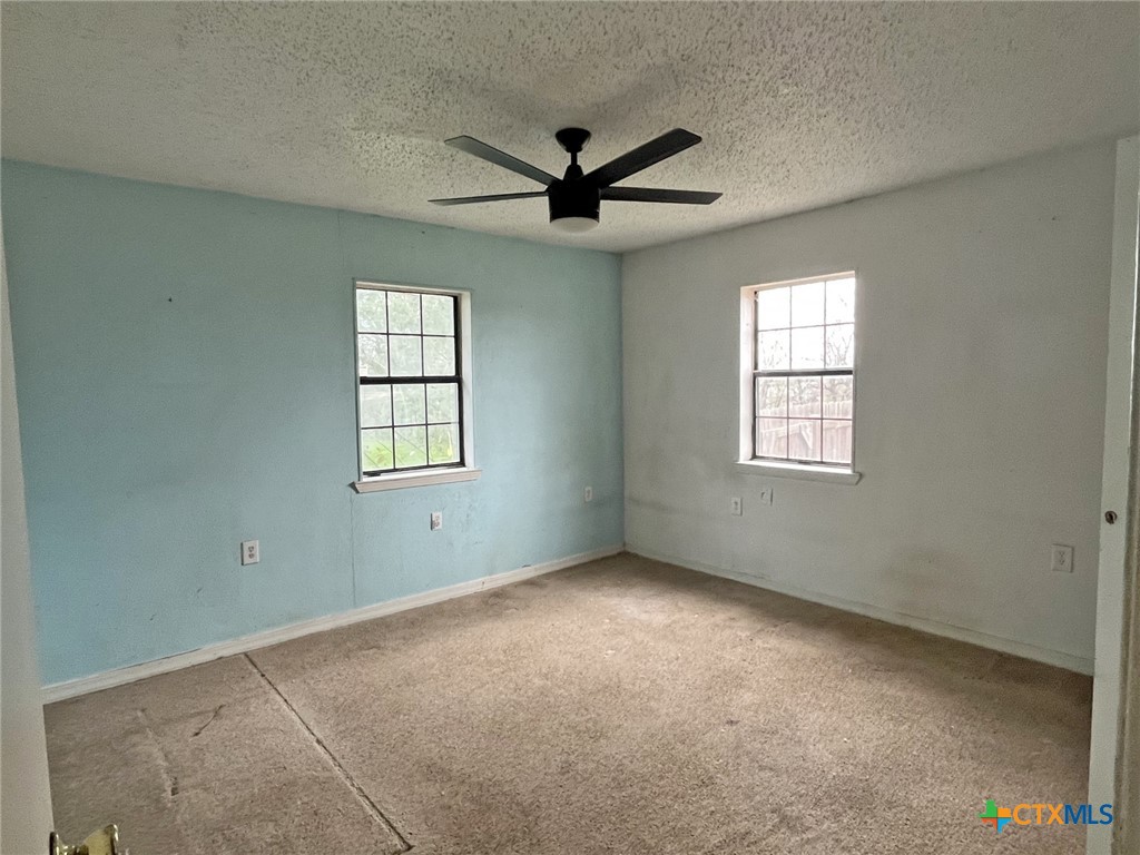 104 East Elms Road Killeen, TX 76542 - Photo 12 of 24 an empty room with windows and ceiling fan