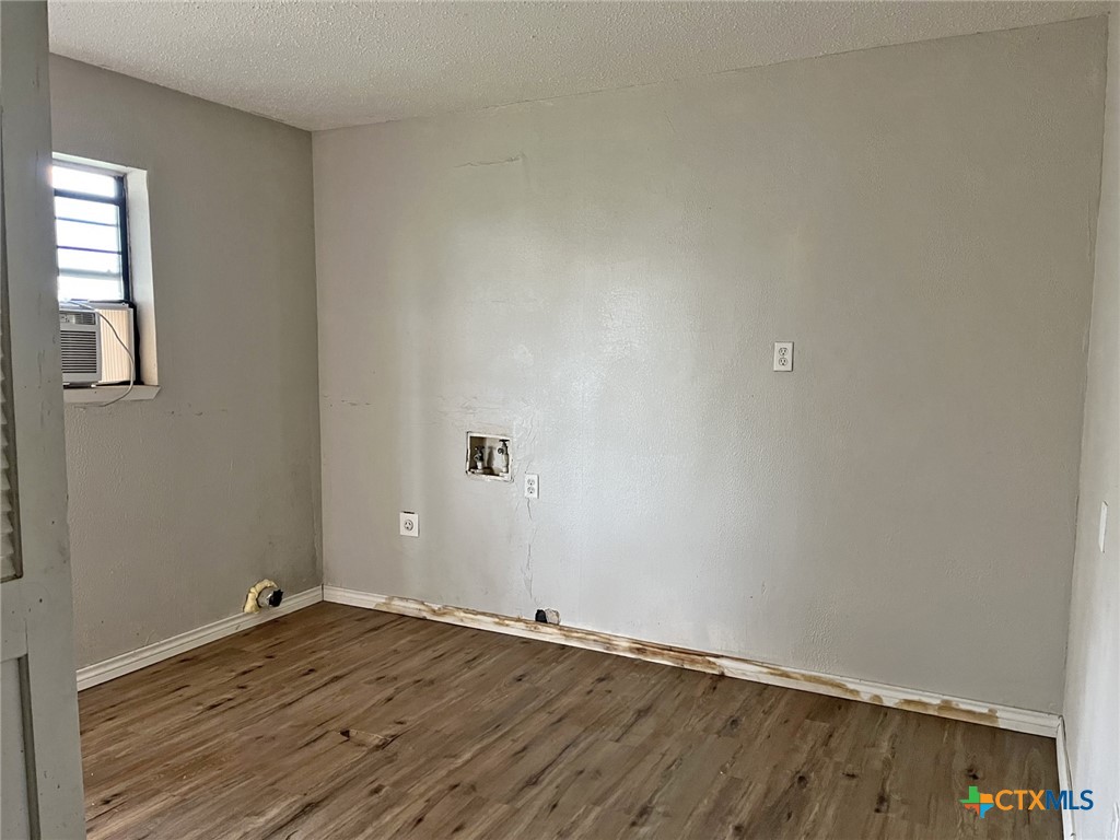 104 East Elms Road Killeen, TX 76542 - Photo 18 of 24 an empty room with wooden floor and window