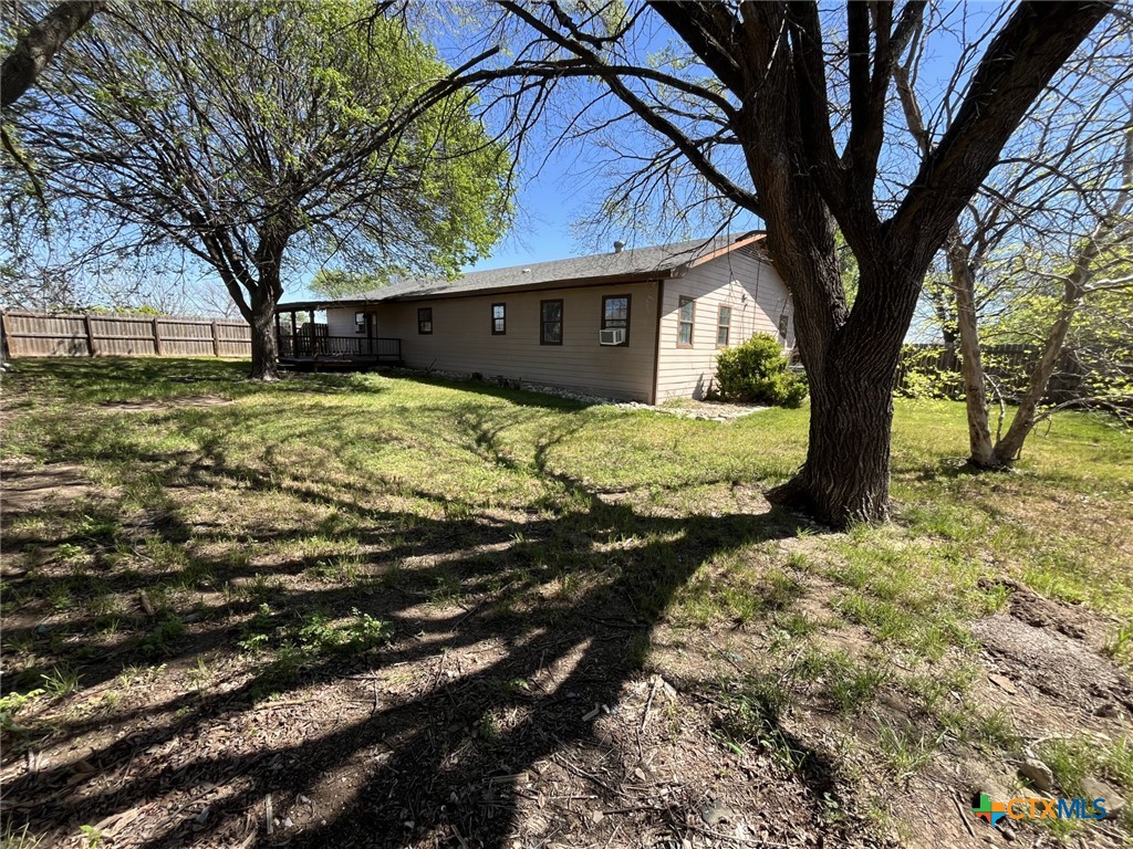 104 East Elms Road Killeen, TX 76542 - Photo 22 of 24 a backyard of a house with large trees and a big yard