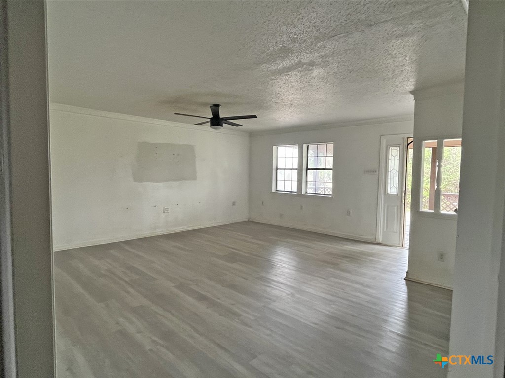 104 East Elms Road Killeen, TX 76542 - Photo 3 of 24 wooden floor in an empty room with a window