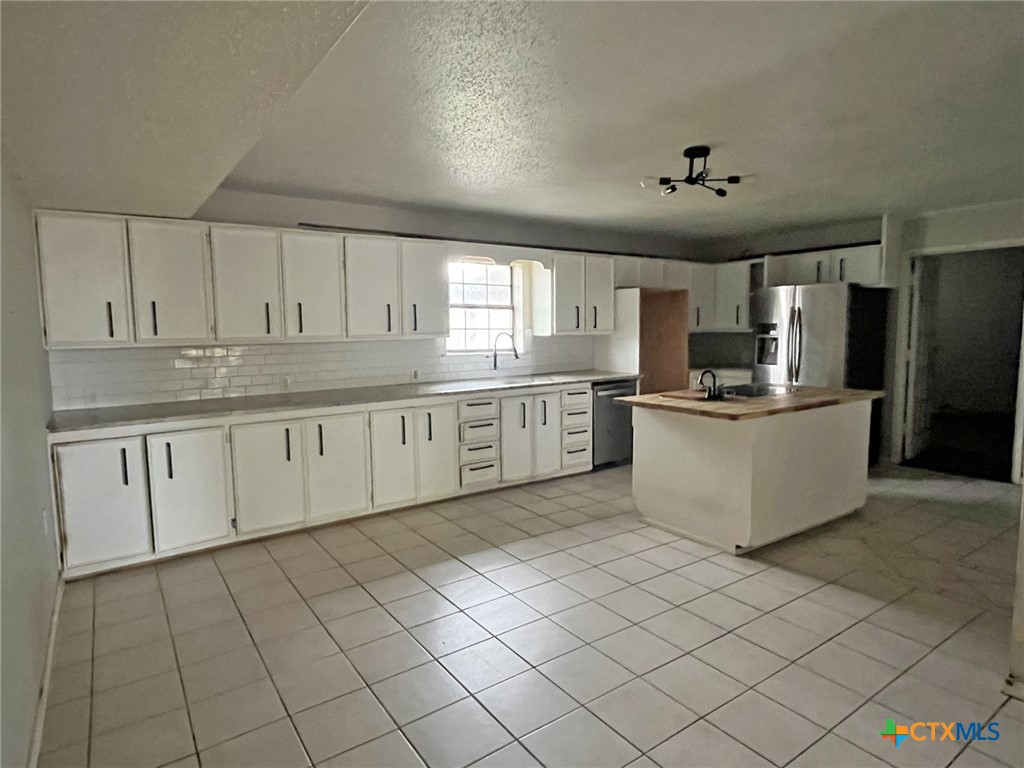 104 East Elms Road Killeen, TX 76542 - Photo 5 of 24 a kitchen with stainless steel appliances granite countertop a stove sink and cabinets