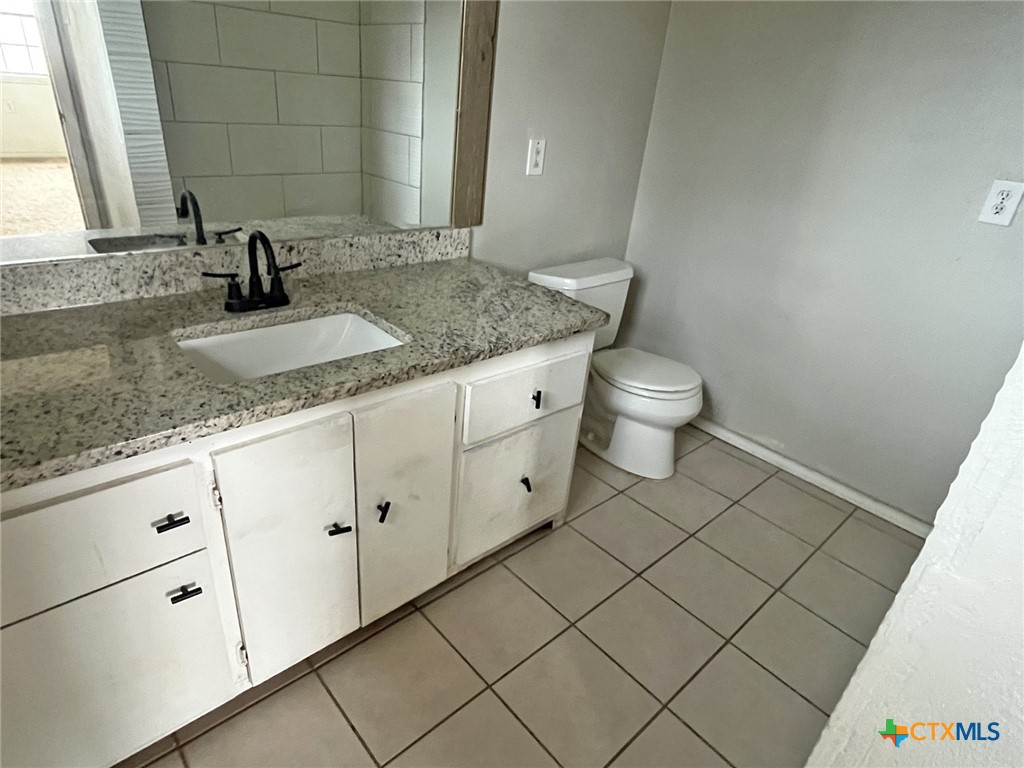 104 East Elms Road Killeen, TX 76542 - Photo 8 of 24 a bathroom with a granite countertop sink and a mirror