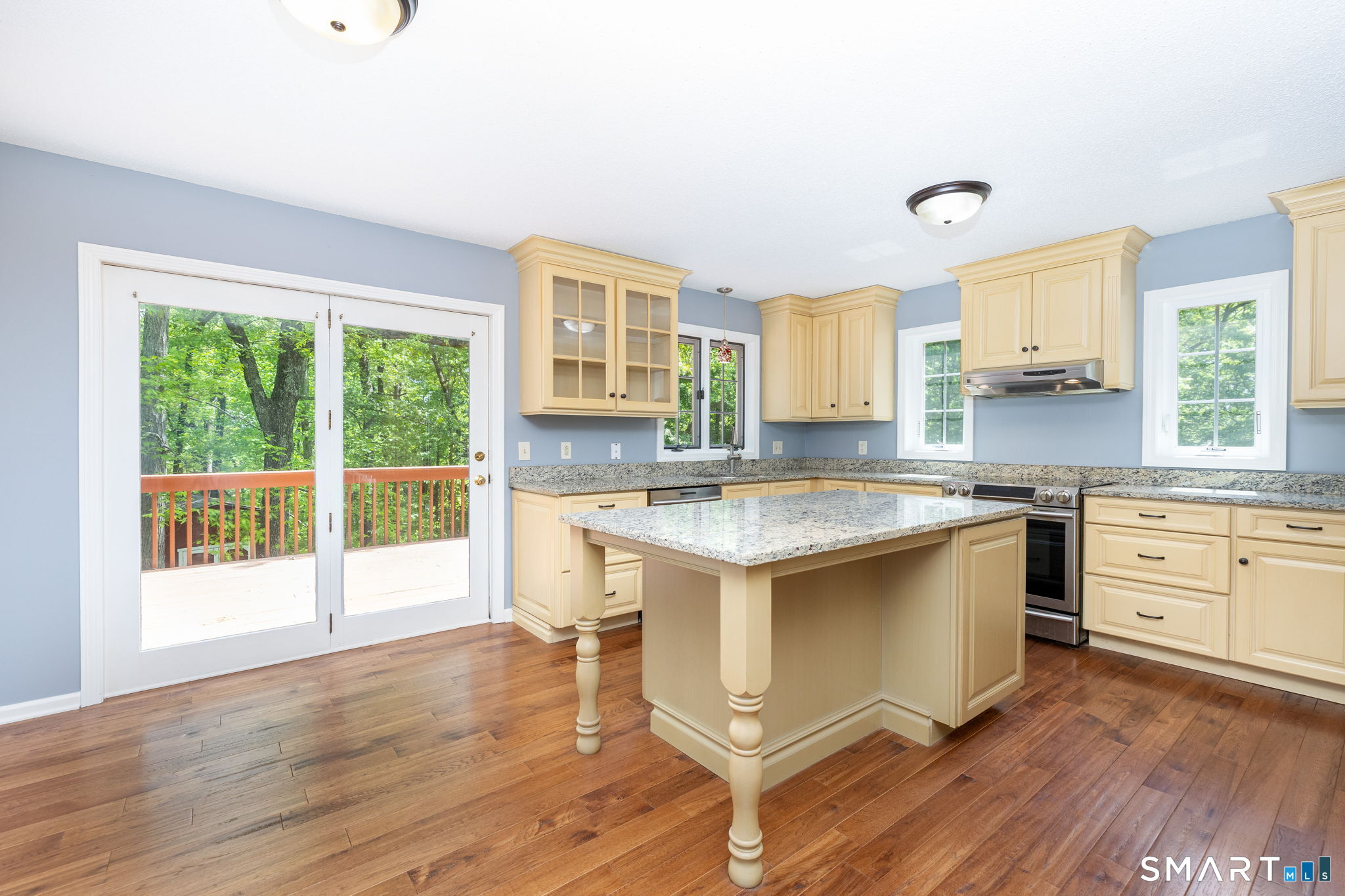 175 Vernon Street Manchester, CT 06042 - Photo 3 of 38 a kitchen with stainless steel appliances granite countertop a stove a sink and a granite counter tops with wooden floors