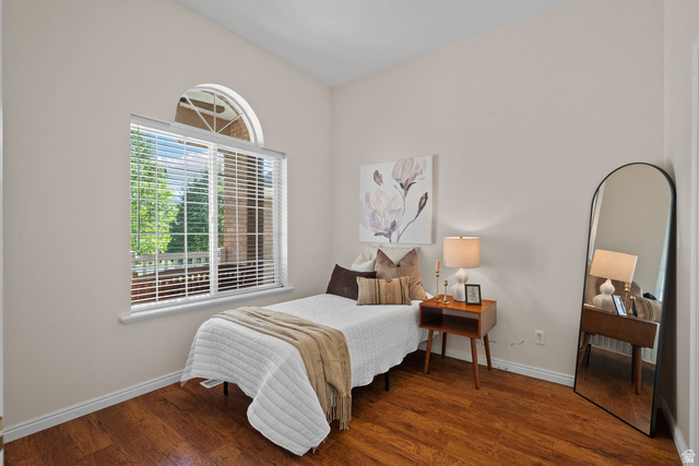 555 East 1700 N Street Mapleton, UT 84664 - Photo 25 of 49 Room featuring wood-finish flooring, a large window with blinds, an arched transom window, and neutral wall paint