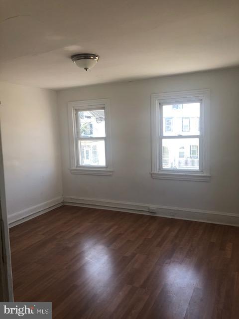 60 Walnut Street Salem, NJ 08079 - Photo 9 of 11 an empty room with wooden floor and windows