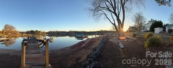 a view of a lake with houses in the back