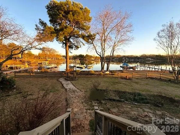 a view of a yard with wooden fence