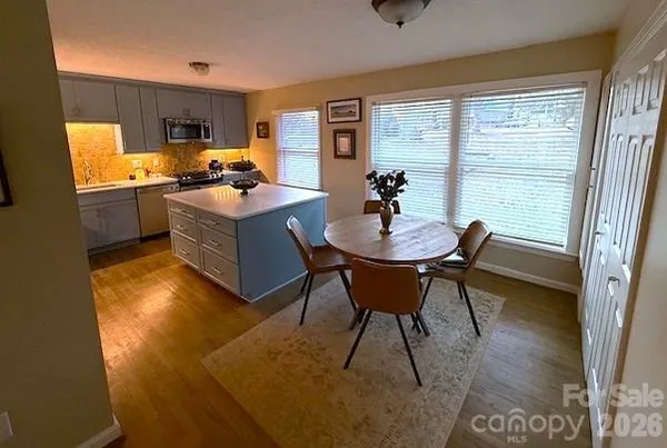 a kitchen with a table chairs stove and refrigerator