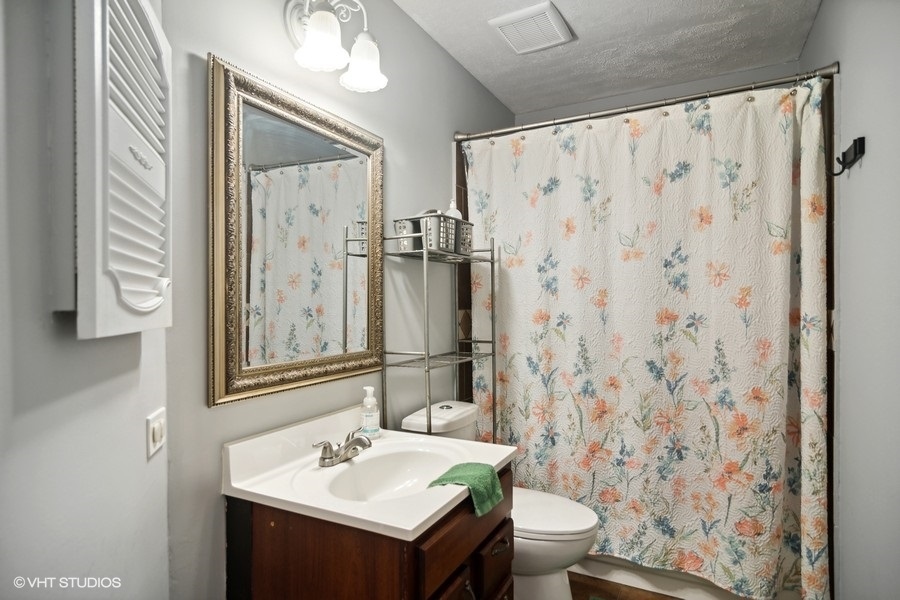 2110 Savannah Road Elgin, IL 60123 - Photo 12 of 17 a bathroom with a sink toilet and shower