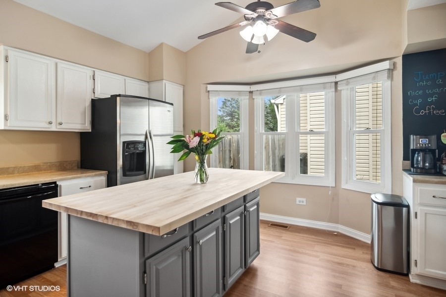 2110 Savannah Road Elgin, IL 60123 - Photo 7 of 17 a kitchen with stainless steel appliances granite countertop a sink a refrigerator and a stove