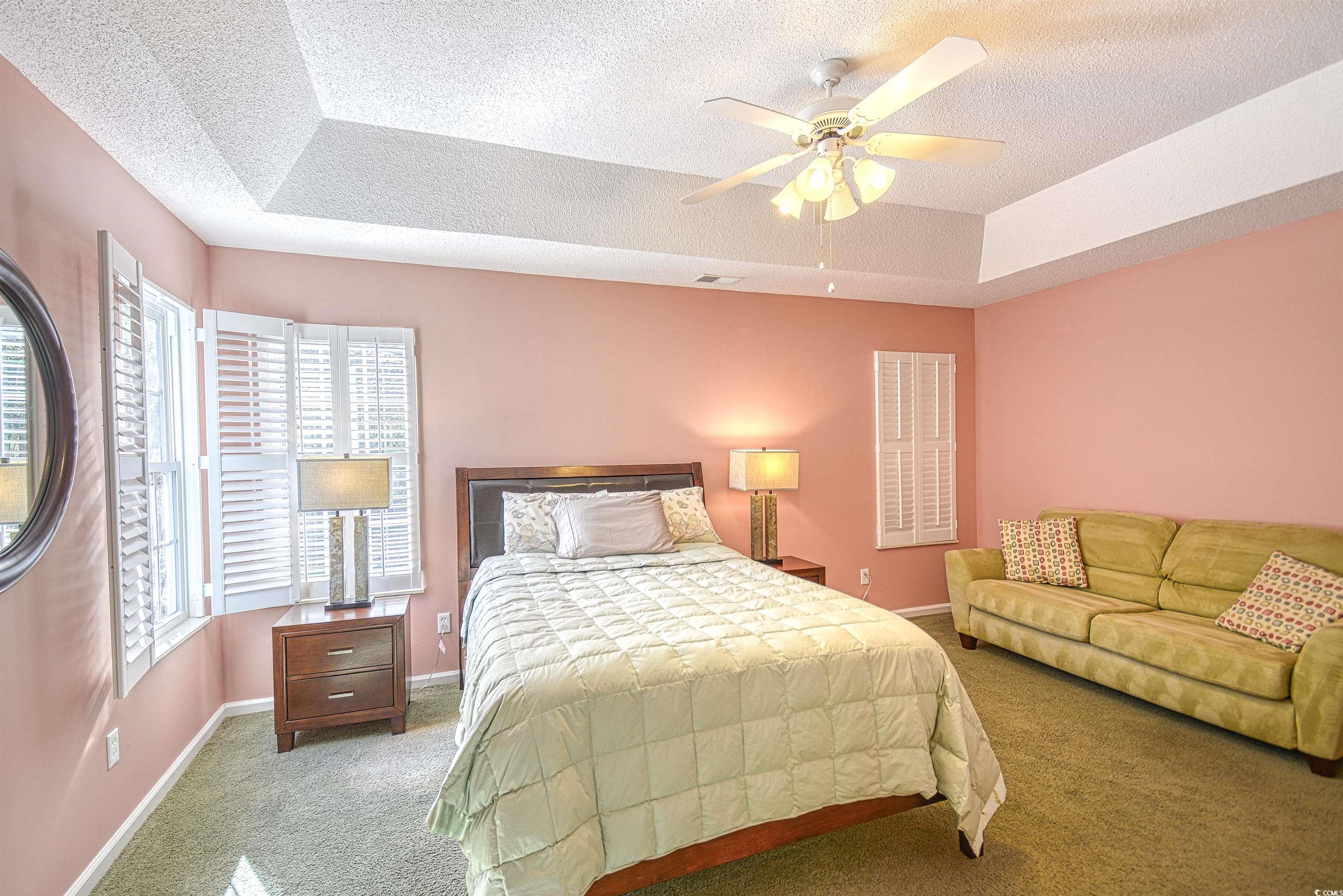 651 Bluebird Lane Murrells Inlet, SC 29576 - Photo 17 of 34 Bedroom featuring carpet, ceiling fan, a raised ce